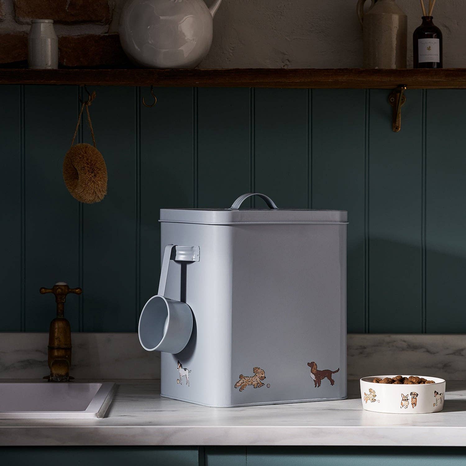 Gray pet food container with measuring cup on a kitchen counter