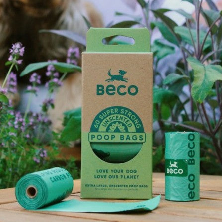 Beco poop bags packaging with green bags on a wooden surface with plants in the background