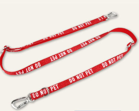 Red dog leash with 'DO NOT PET' text on a white background
