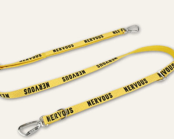 Yellow dog leash with 'Nervous' text on a white background
